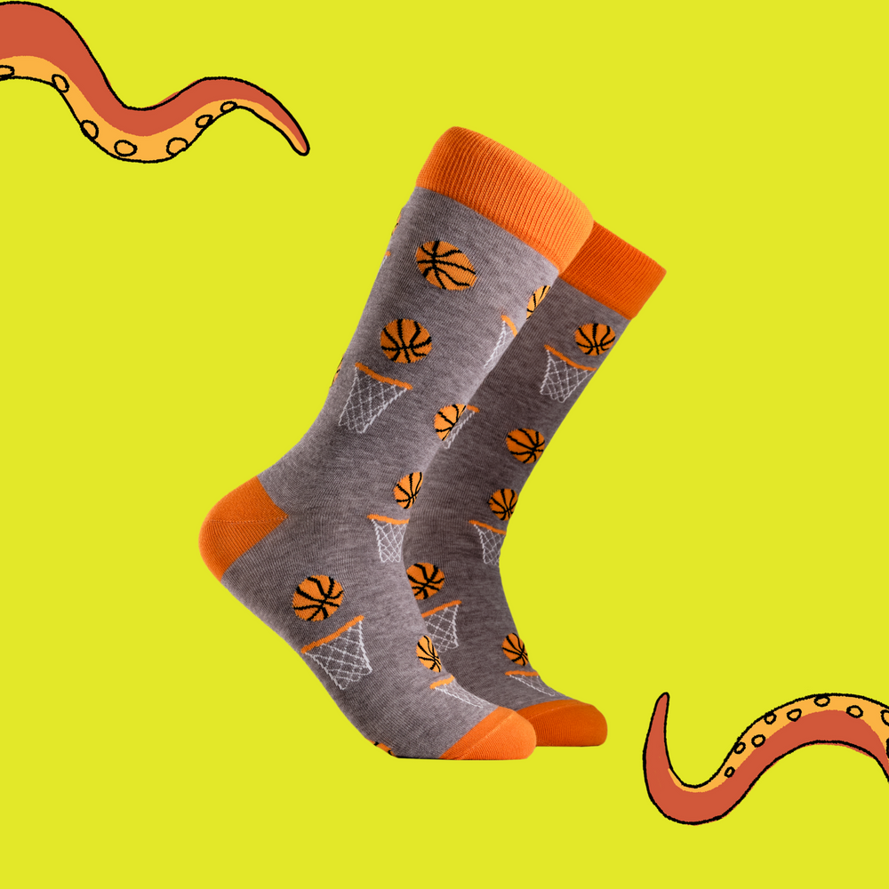 Basketball Socks. A pair of socks depicting basketballs. Grey legs, orange cuff, heel and toe.