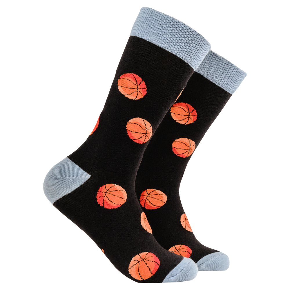 Basket Balls Bamboo Socks. A pair of socks featuring basketballs. Black legs, blue toe heel and cuff. 