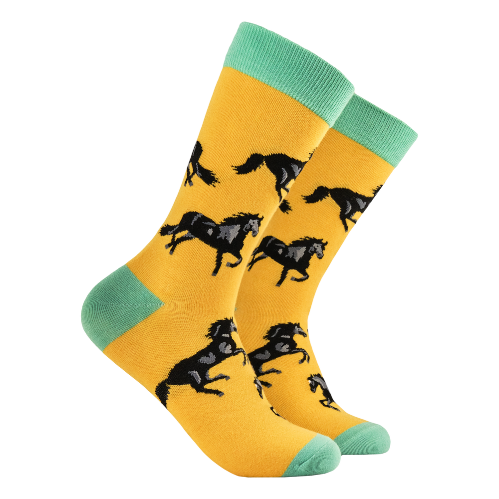 Black Stallion Socks. A pair of socks with a black stallion motif. Yellow legs, green heel toe and cuff. 