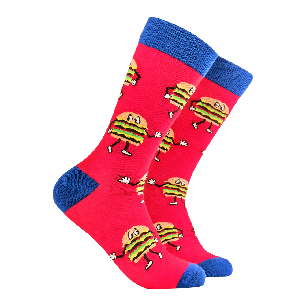 Burger Time Socks. A pair of socks featuring dancing burgers. Red legs, blue eel, toe and cuff. 