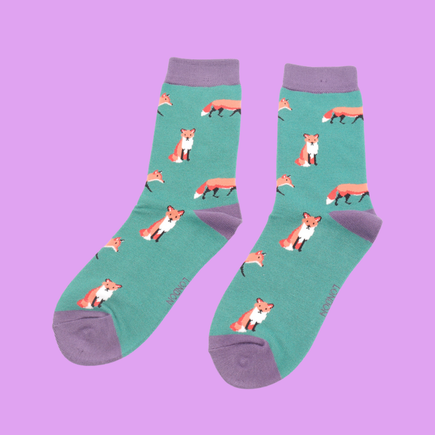 
                  
                    A pair of socks featuring a cute fox design. Light green legs, purple cuff, heel and toe.
                  
                