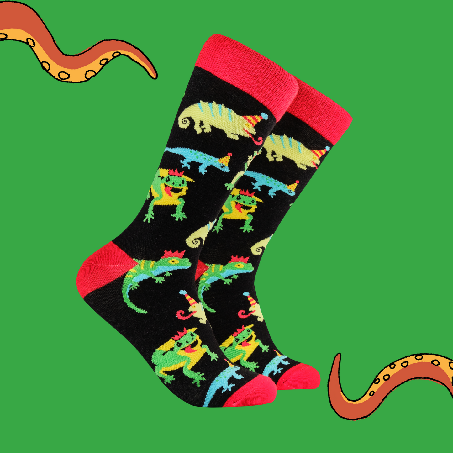 A pair of socks depicting lizards in party hats. Black legs, red cuffs, heels and toe. 