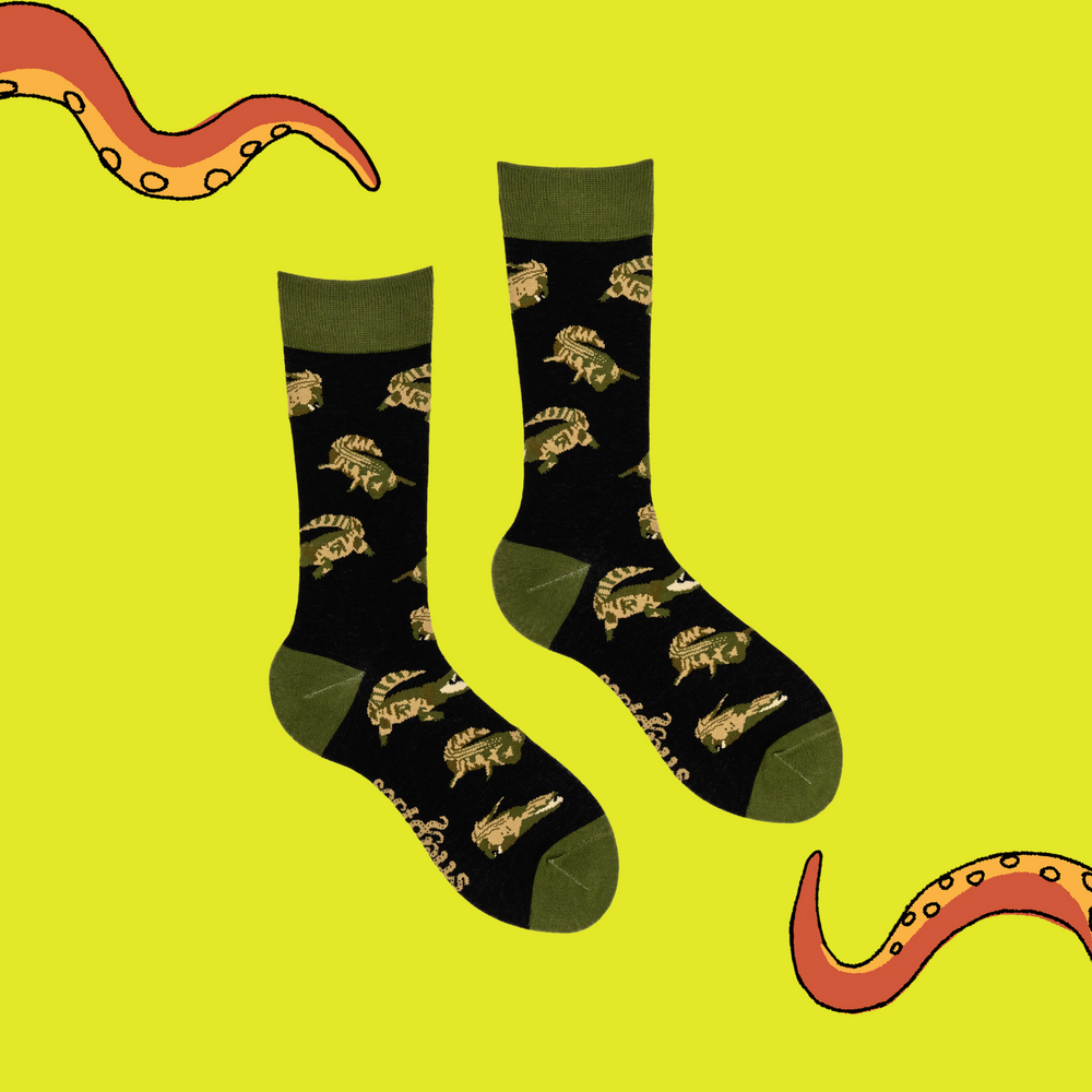 
                      
                        A pair of socks depicting crocodiles. Dark blue legs, green cuff, heel and toe.
                      
                    