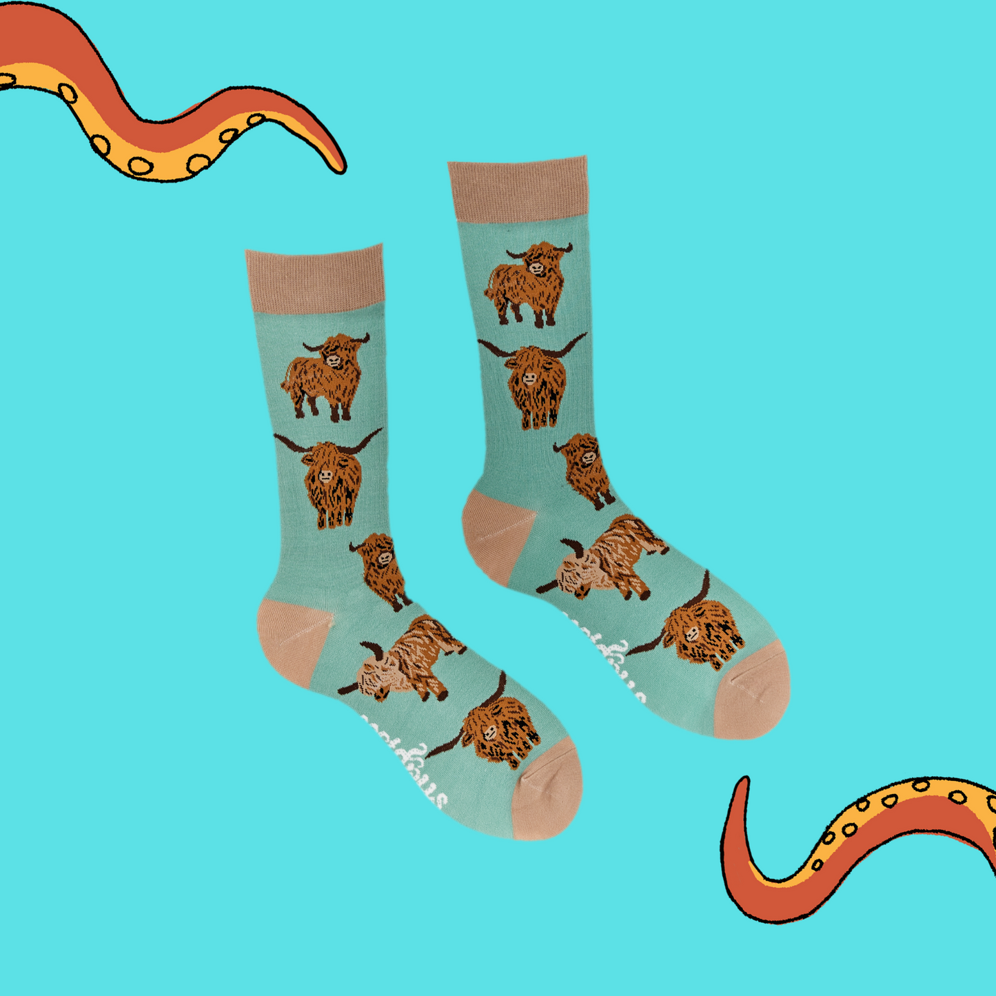 
                  
                    A pair of socks depicting highland cows. Green legs, brown cuff, heel and toe.
                  
                