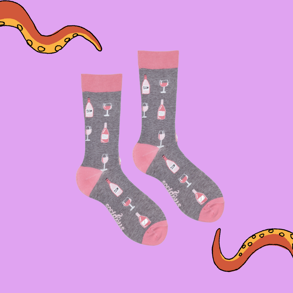 
                  
                    A pair of socks depicting Rose wine bottles and glasses. Grey legs, pink cuff, heel and toe.
                  
                