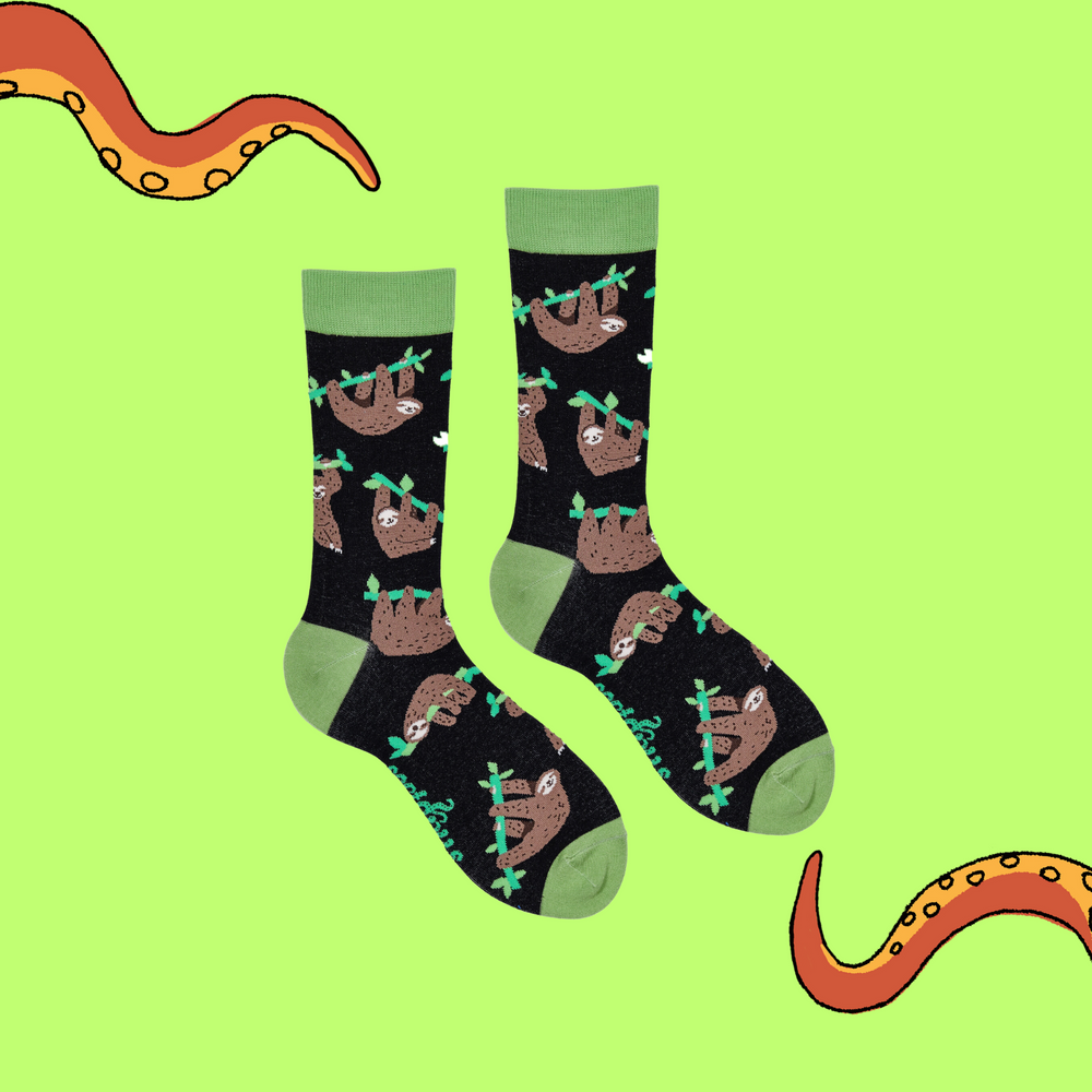
                  
                    A pair of socks depicting lazy sloths. Black legs, green cuff, heel and toe.
                  
                