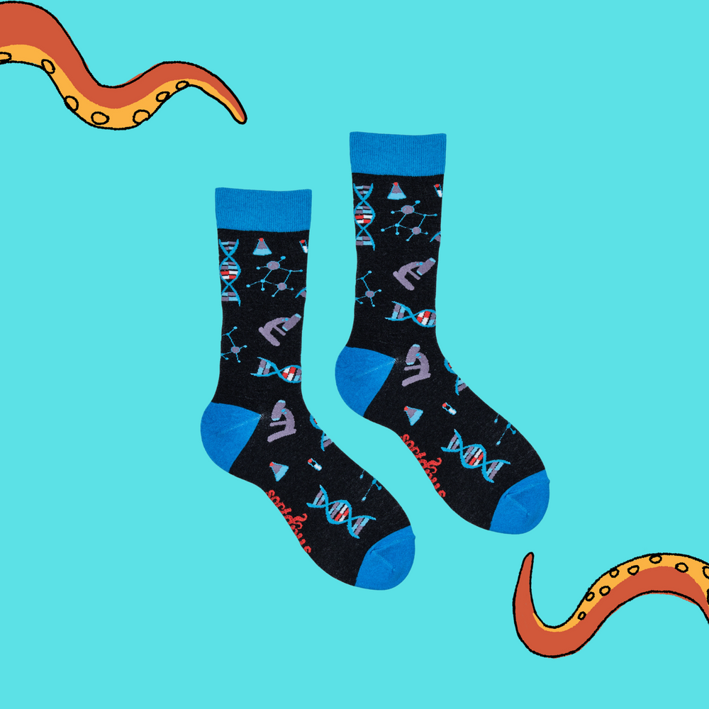 
                      
                        A pair of socks depicting DNA and microscopes. Black legs, light blue cuff, heel and toe.
                      
                    