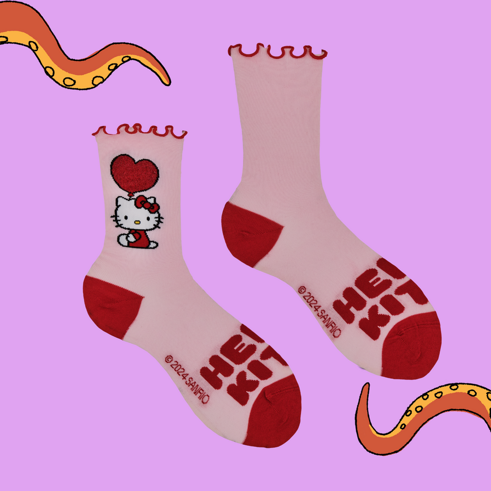 
                      
                        A pair of socks depicting Japanese icon Hello Kitty. Pink legs, read toe and heel with a frilly red cuff.
                      
                    