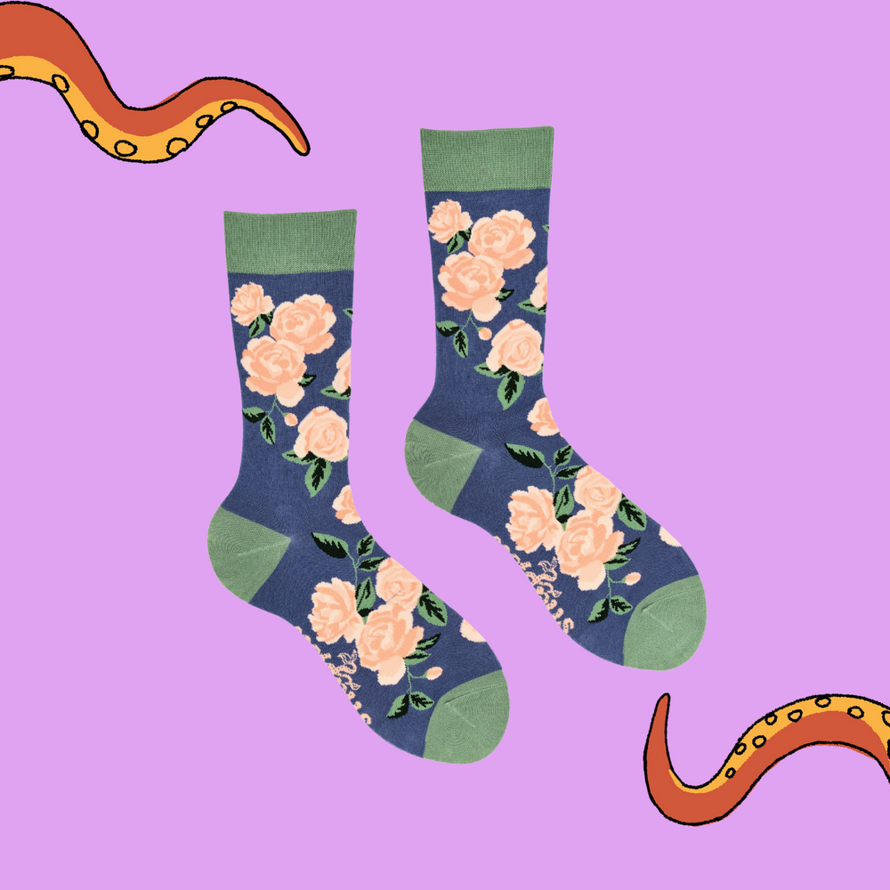 
                      
                        Rose Floral Bamboo Socks. A pair of socks depicting pink roses. Blue legs, green cuff, heel and toe.
                      
                    