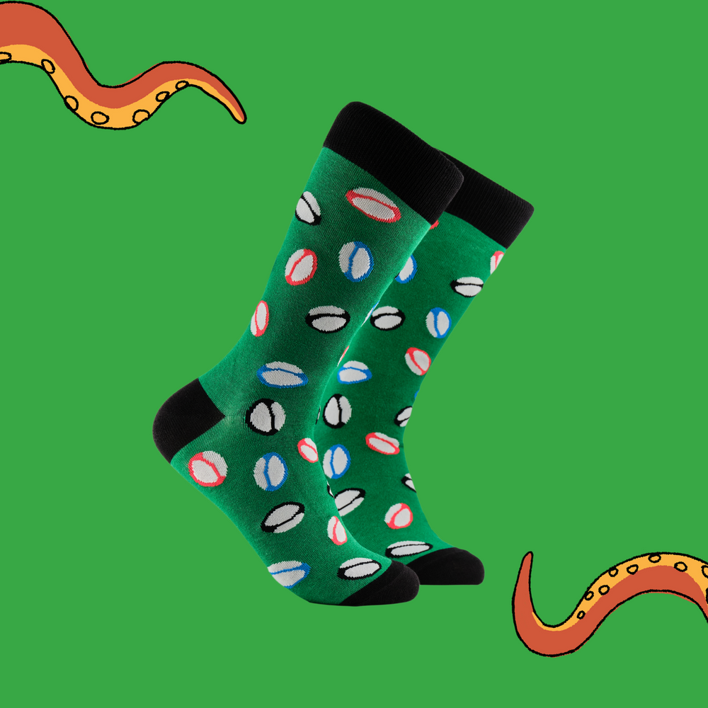 
                      
                        A pair of socks depicting rugby balls. Green legs, black cuff, heel and toe.
                      
                    