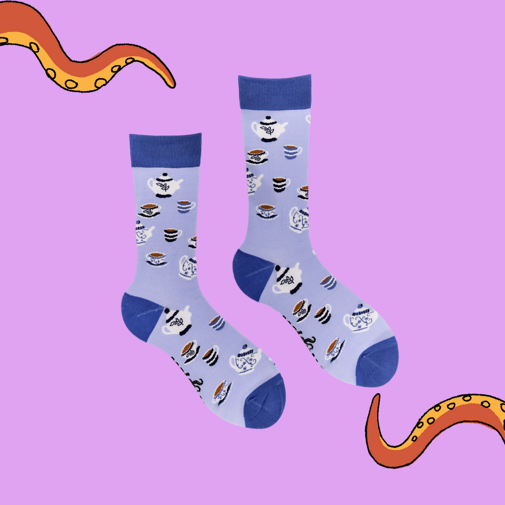 
                  
                    A pair of socks depicting tea cups and tea pots. Light blue legs, blue cuff, heel and toe.
                  
                