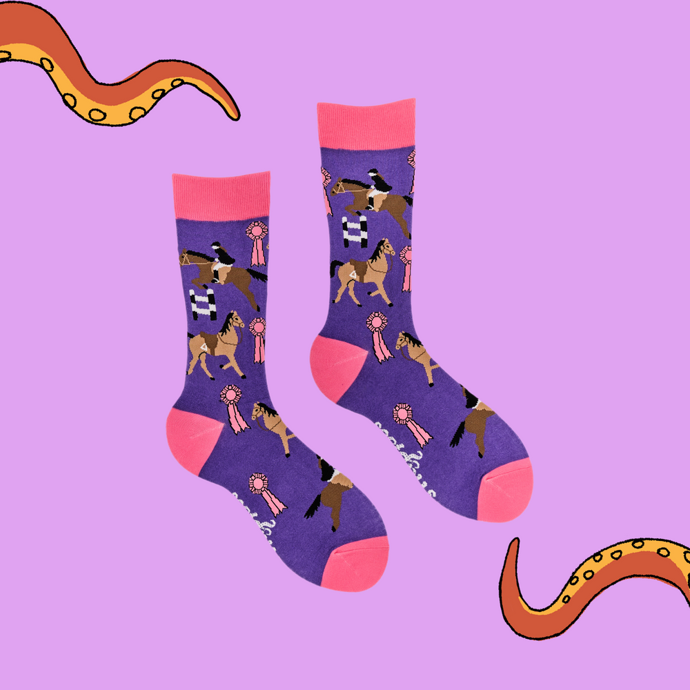 
                      
                        A pair of socks depicting tea cups and show jumping horses. Purple legs, pink cuff, heel and toe.
                      
                    