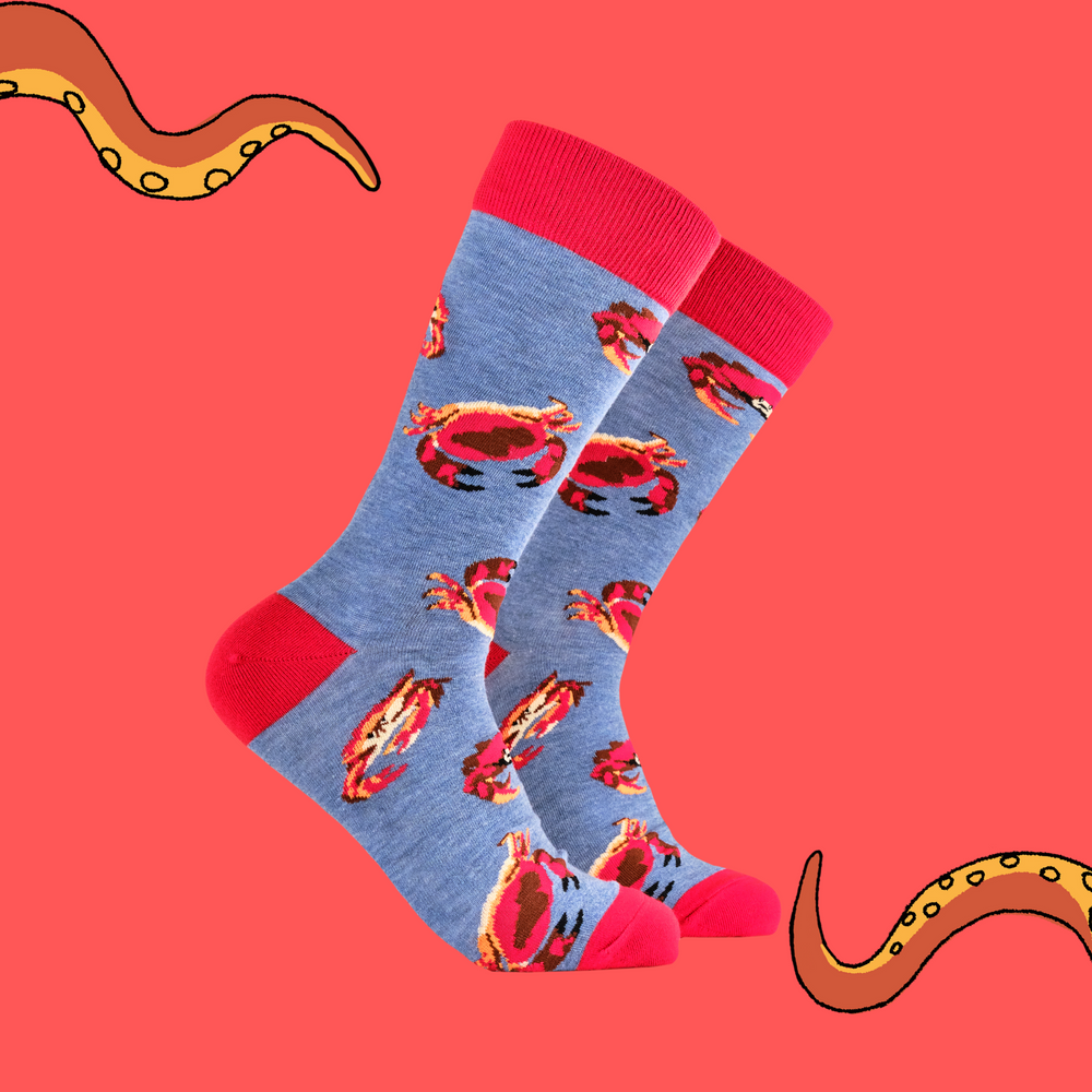 
                      
                        A pair of socks featuring a crab motif. Blue legs, red heel, toe and cuff. 
                      
                    