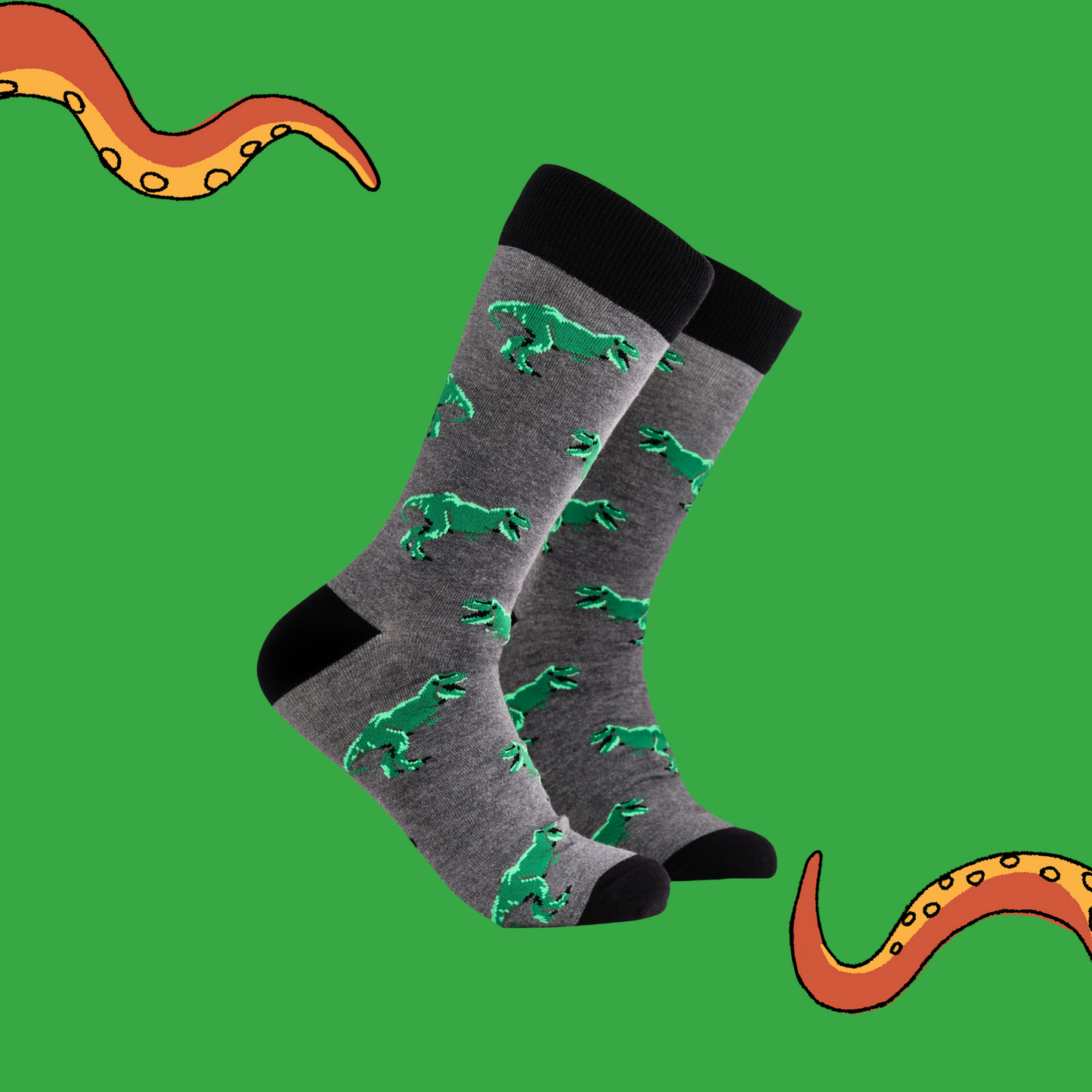 A pair of socks depicting T-Rex dinosaurs. Grey legs, black cuff, heel and toe.