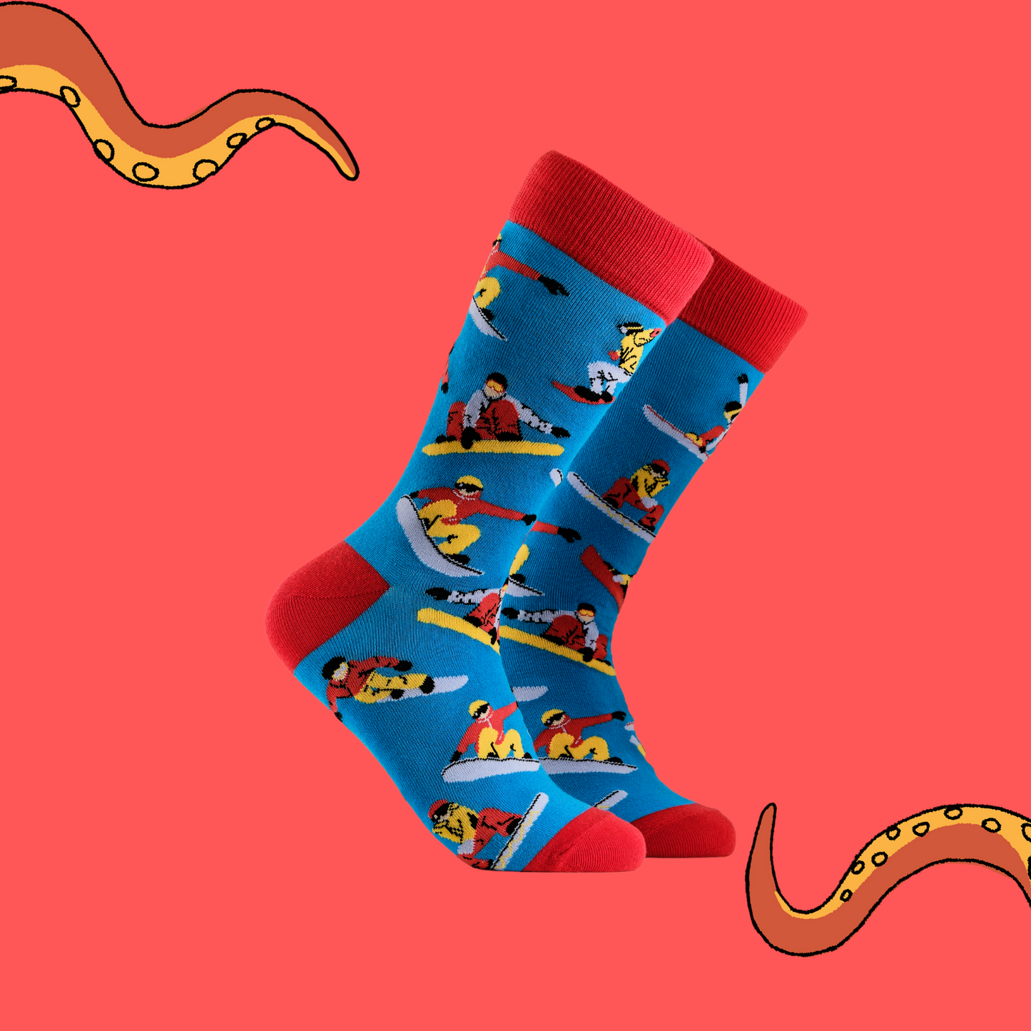 A pair of socks depicting snowboarders. Blue legs, red cuff, heel and toe.