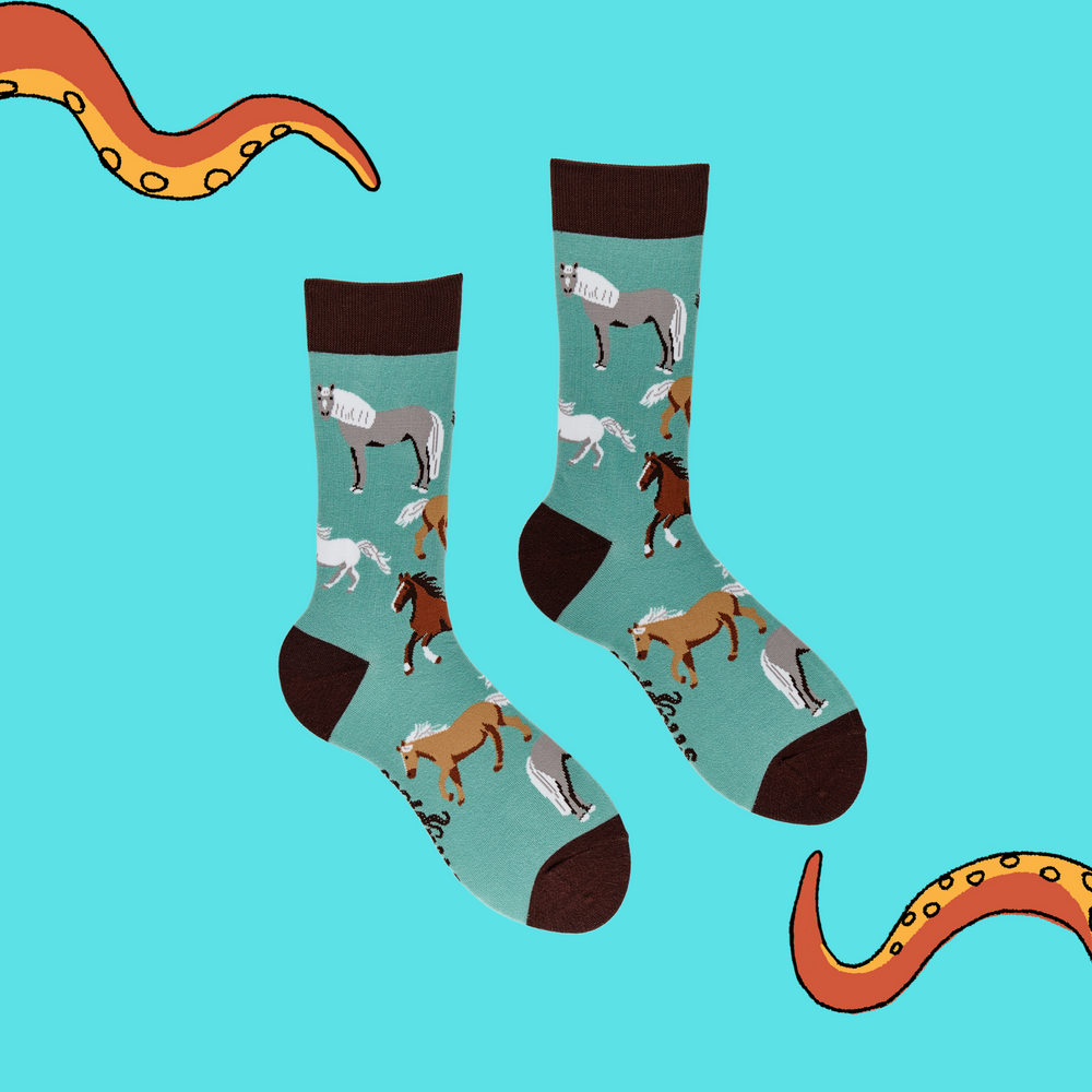 
                      
                        A pair of socks depicting horses. Turquoise legs, brown cuff, heel and toe.
                      
                    