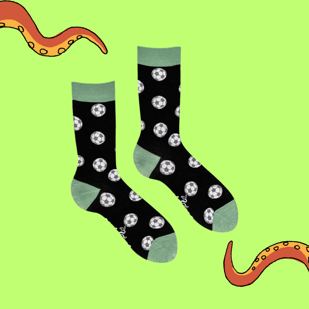 
                      
                        A pair of socks depicting footballs. Black legs, light green cuff, heel and toe.
                      
                    