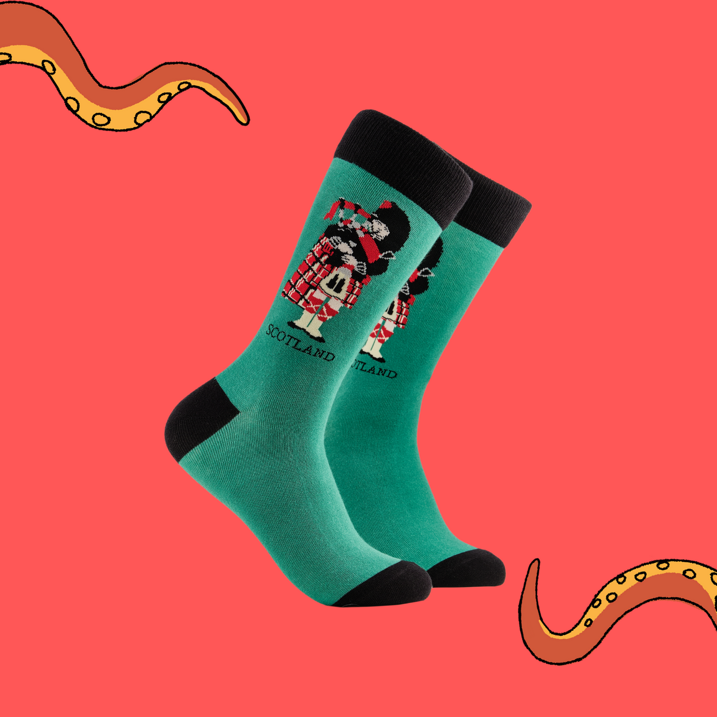 
                  
                    A pair of socks depicting a scotsman playing bag pipes. Green legs, black cuff, heel and toe.
                  
                