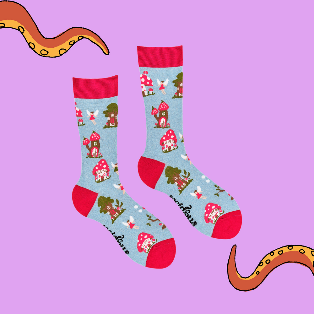 
                      
                         A pair of socks depicting fairies and toadstools. Light blue legs, red cuff, heel and toe.
                      
                    