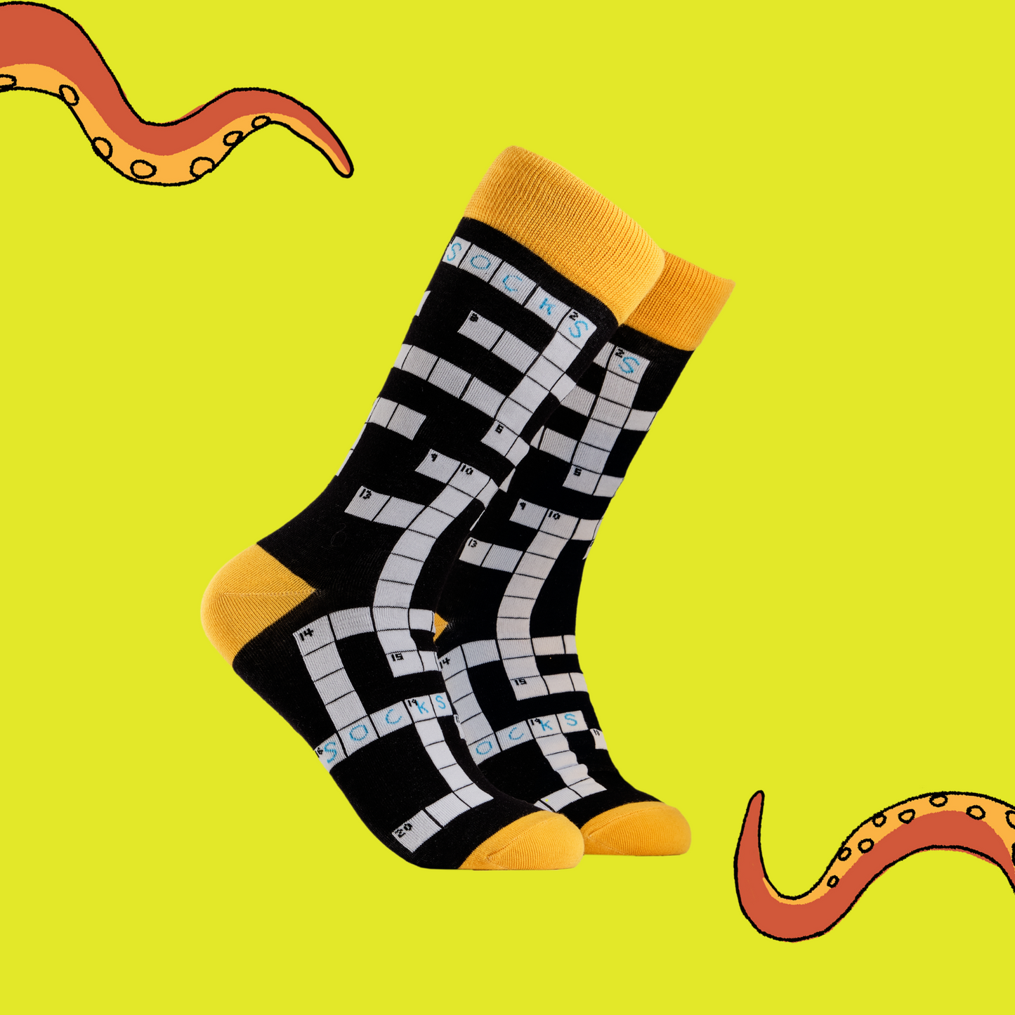 A pair of socks depicting Crosswords. Black legs, yellow cuff, heel and toe.