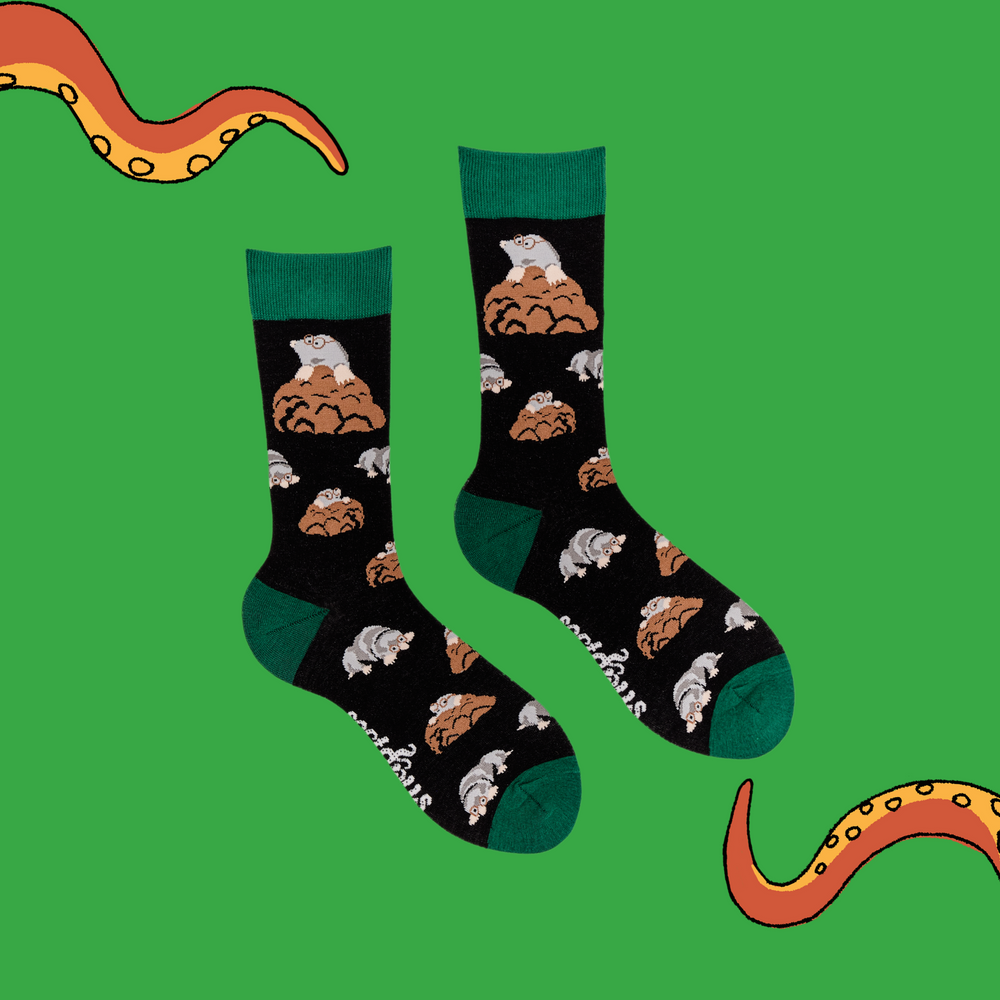 
                      
                        A pair of socks depicting adorable moles digging. Black legs, green cuff, heel and toe.
                      
                    