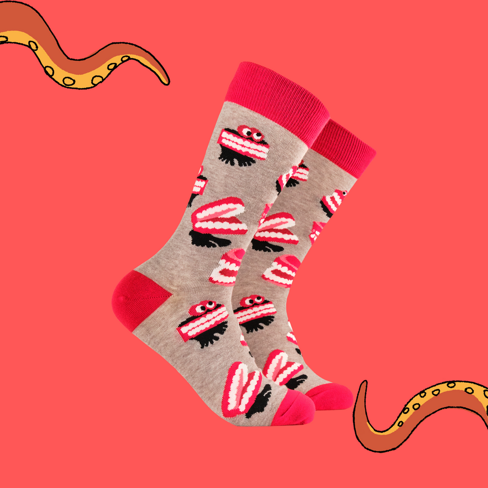 
                      
                        A pair of socks featuring wind up teeth. Brown legs, red heel, toe and cuff. 
                      
                    