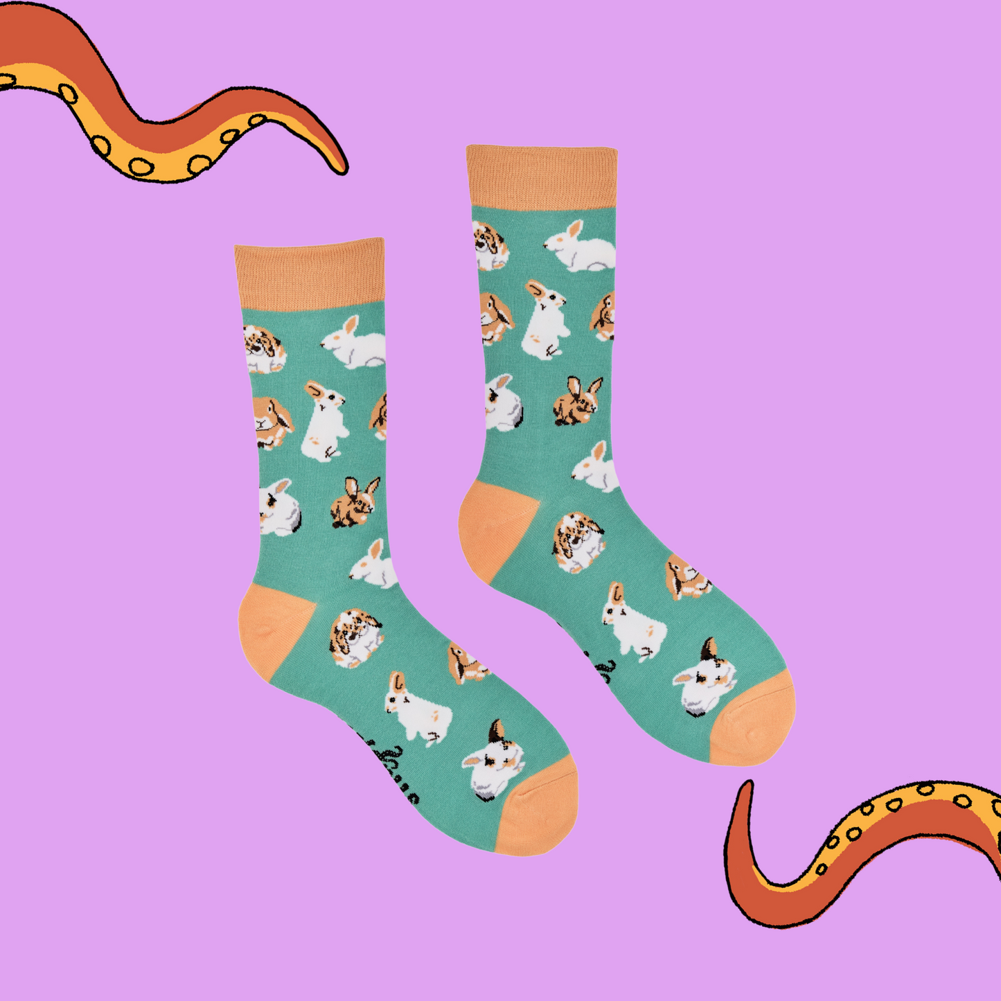 
                  
                    A pair of socks depicting rabbits playing. Green legs, brown cuff, heel and toe.
                  
                