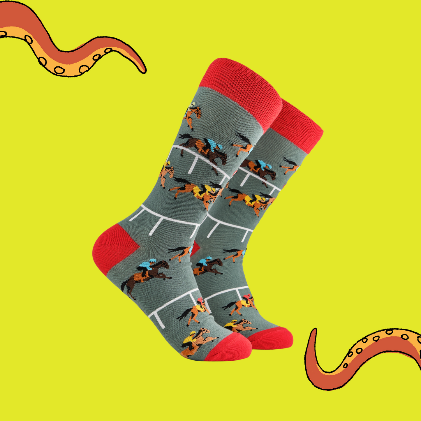 A pair of socks depicting horse racing. Grey legs, red cuff and, heel and toe.