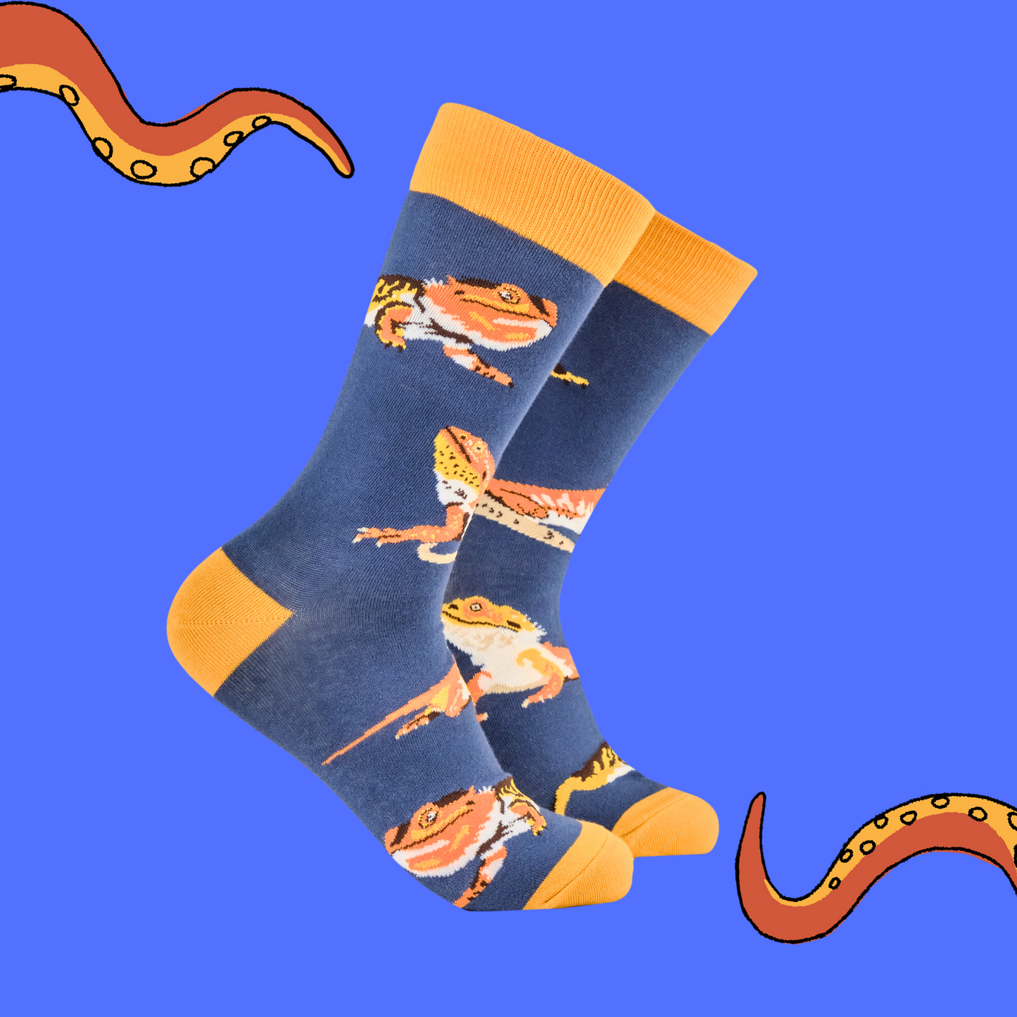 A pair of socks depicting bearded dragons. Blue legs, yellow heel, toe and cuff. 