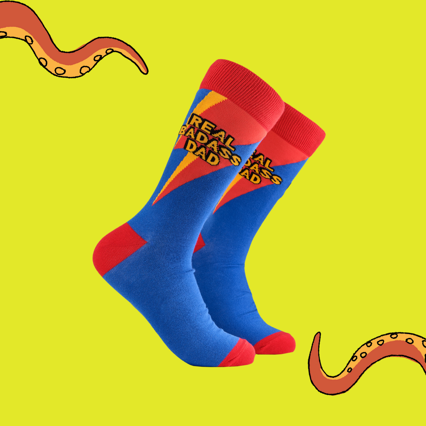 A pair of socks depicting the words Real Badass Dad. Blue legs, red cuff, heel and toe.