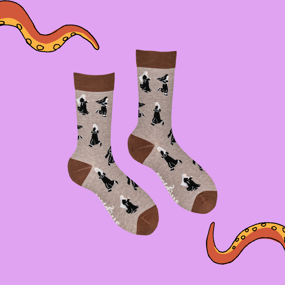 
                      
                        A pair of socks featuring running nuns. Light brown legs, dark brown heel, toe and cuff. 
                      
                    