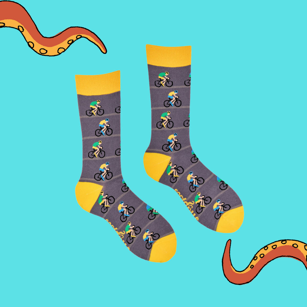 
                  
                    A pair of socks depicting racing cycles. Grey legs, yellow cuff, heel and toe.
                  
                
