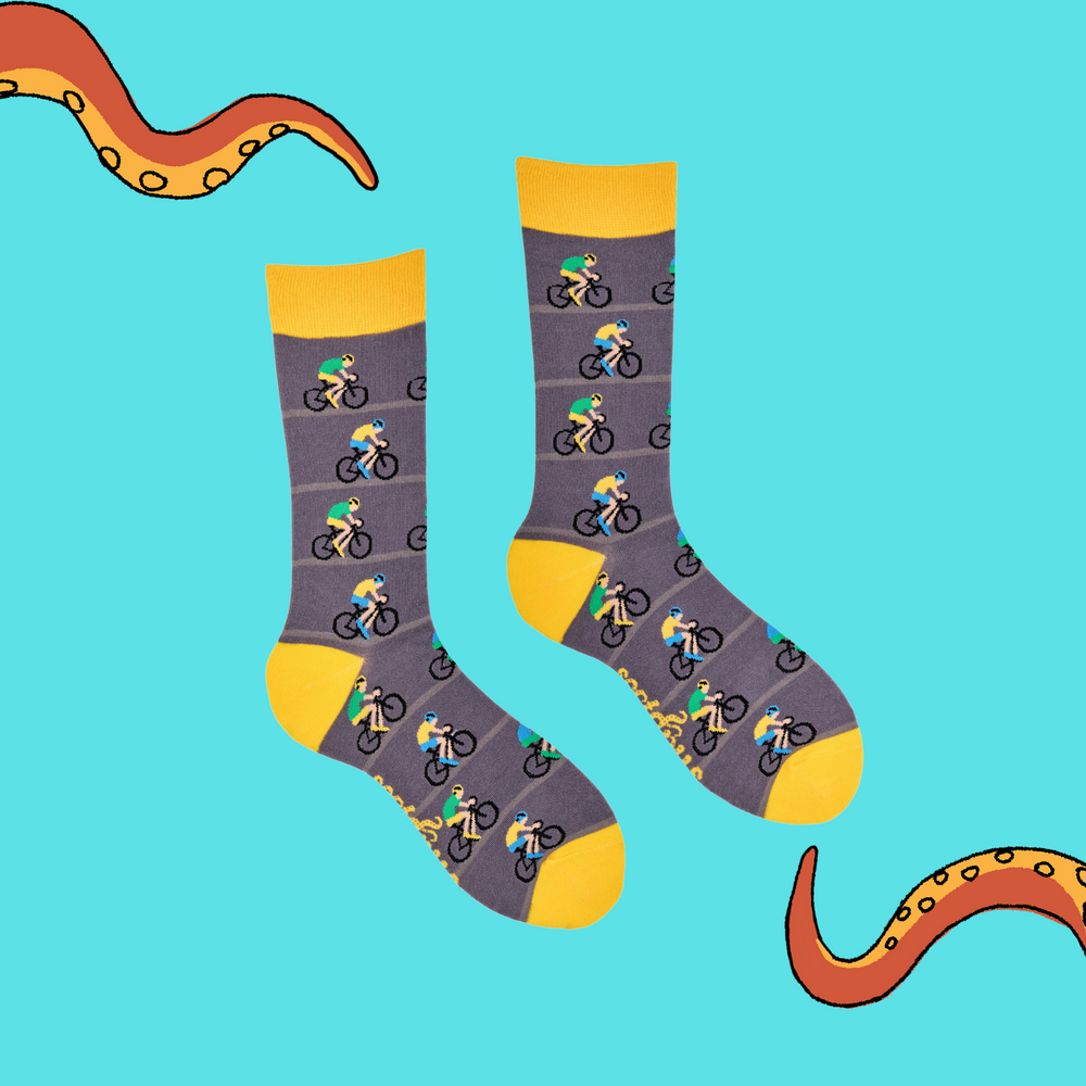 
                      
                        A pair of socks depicting racing cycles. Grey legs, yellow cuff, heel and toe.
                      
                    