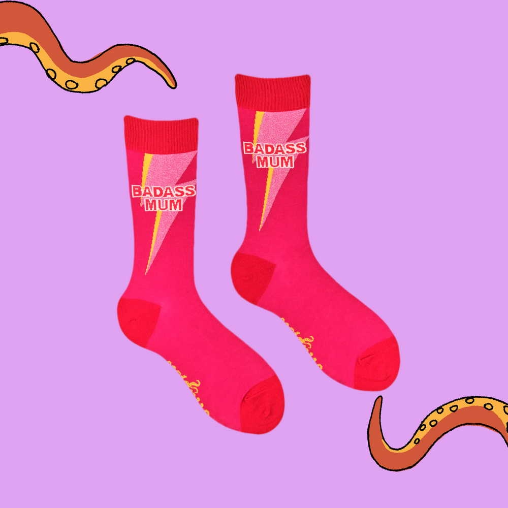 
                      
                        A pair of socks with he slogan Badass Mum. Pink legs, red heel, toe and cuff. 
                      
                    