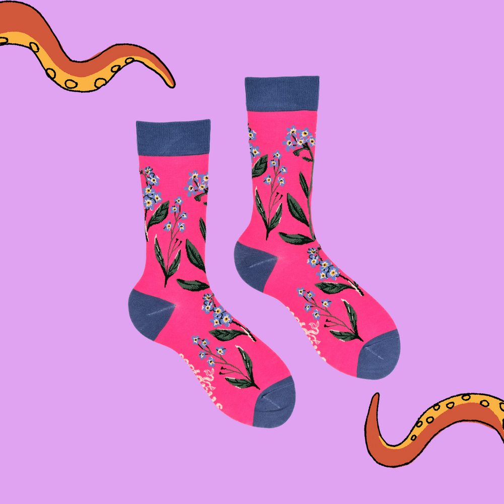 
                      
                        A pair of socks depicting forget me knot flowers. Pink legs, blue cuff, heel and toe.
                      
                    