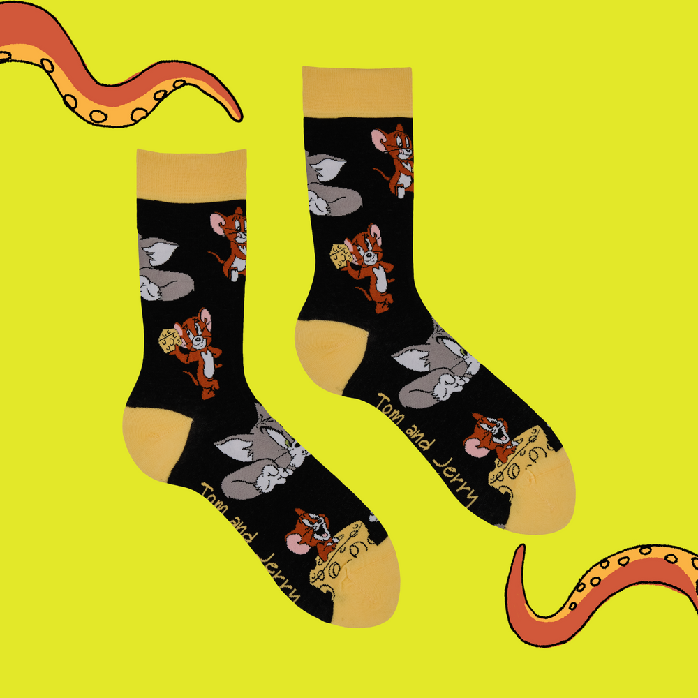 
                      
                        A pair of socks depicting the lovable duo of Tom and Jerry. Black legs, yellow toe, cuff and heel.
                      
                    