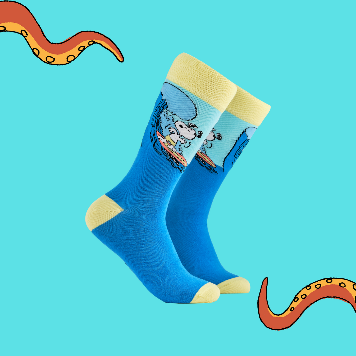 A pair of socks depicting snoopy catching some waves. Blue legs, yellow cuff, heel and toe.