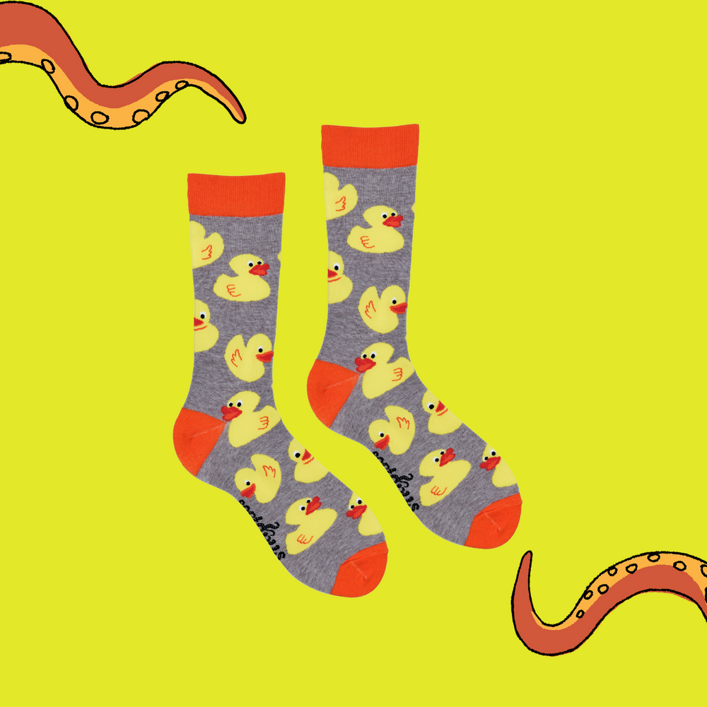 
                  
                    A pair of socks depicting rubber ducks. Grey legs, orange cuff, heel and toe.
                  
                