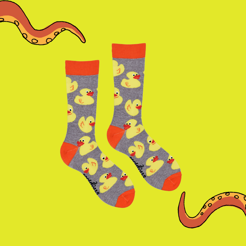 
                      
                        A pair of socks depicting rubber ducks. Grey legs, orange cuff, heel and toe.
                      
                    