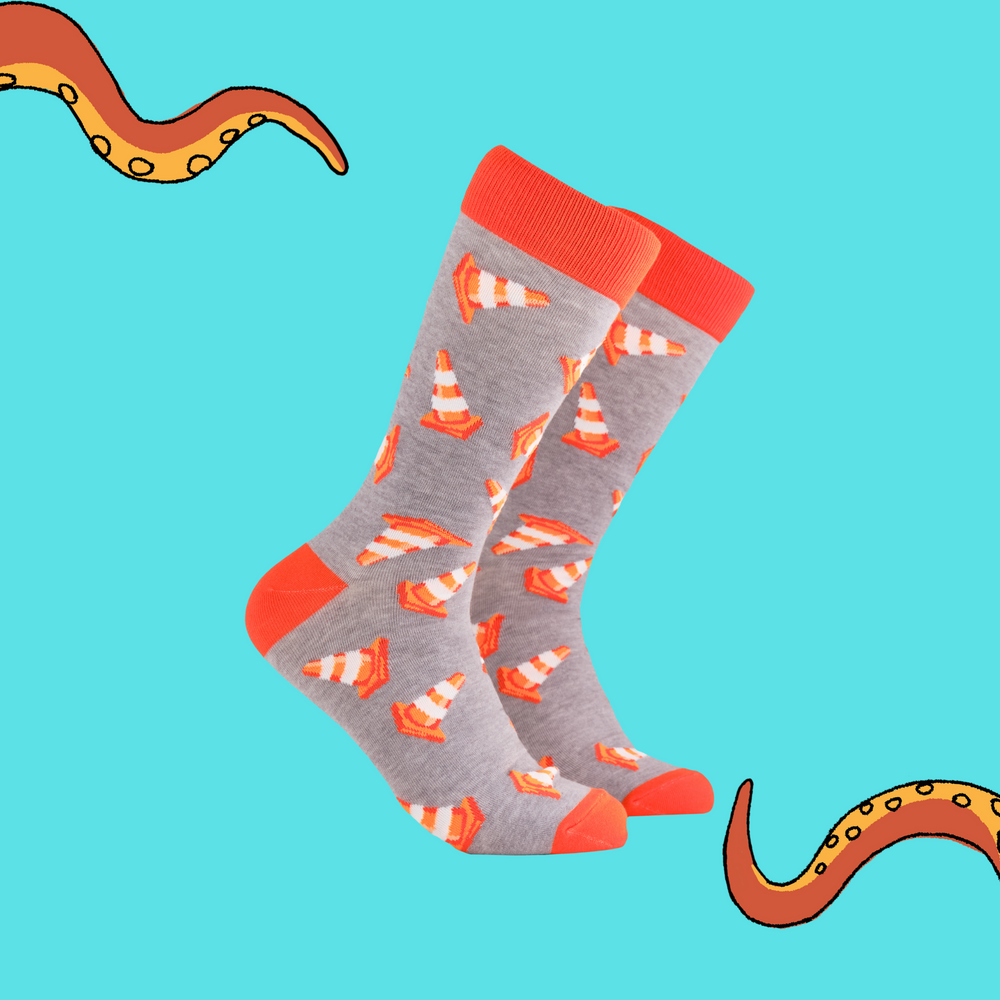 A pair of socks depicting traffic cones. Grey legs, orange cuff, heel and toe.