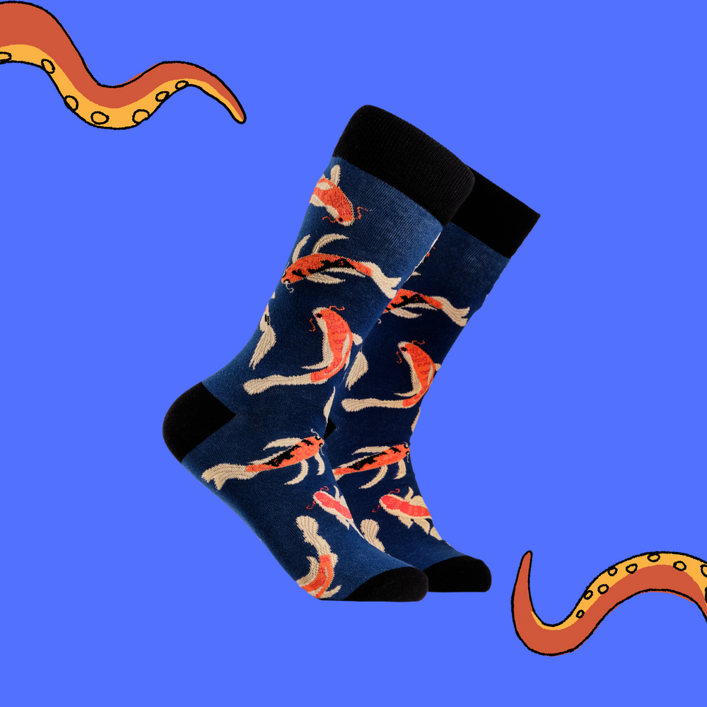 A pair of socks depicting Koi Carp. Dark blue legs, black cuff, heel and toe.