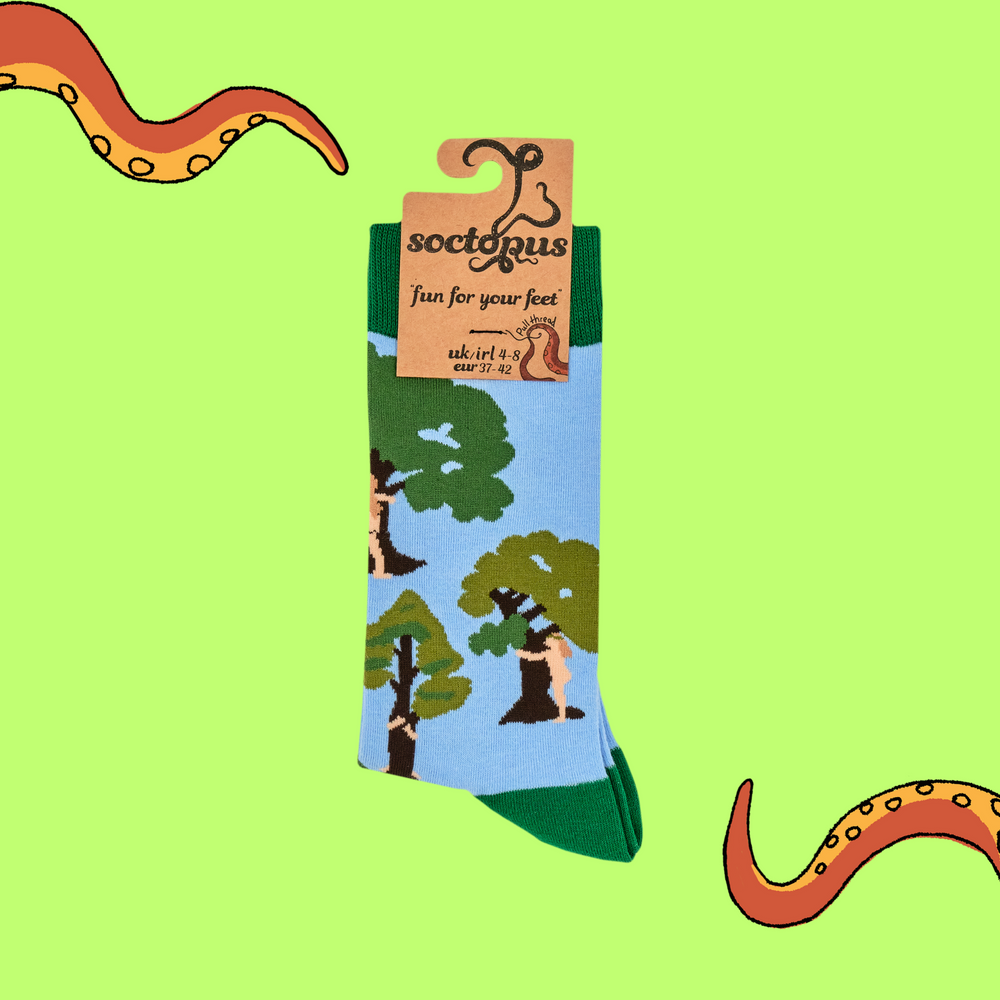 
                      
                        A pair of socks featuring tree huggers. Blue legs, green heel, toe and cuff. 
                      
                    