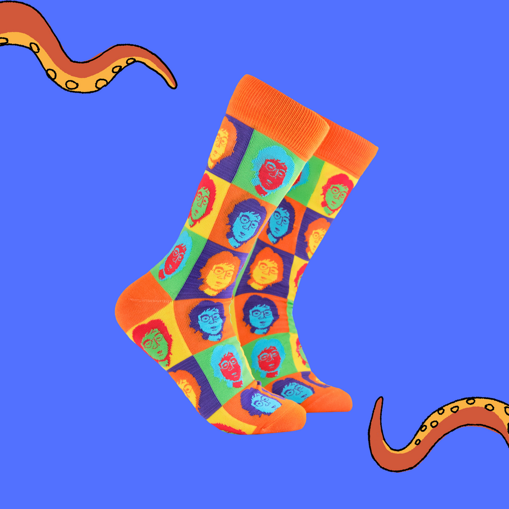 A pair of socks depicting John Lennon's face. Multicoloured legs, orange cuff, heel and toe.