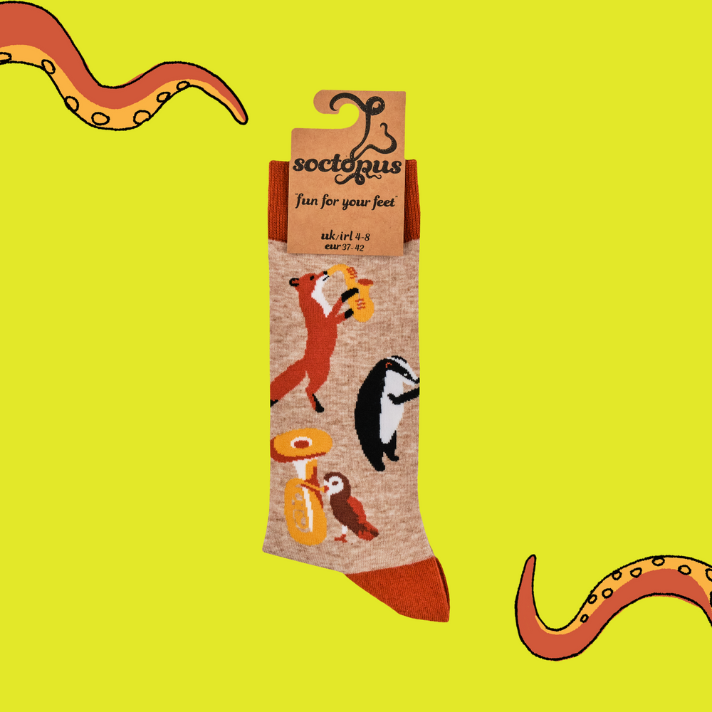 
                      
                        A pair of socks featuring some woodland creatures playing musical instruments. Brown legs, orange cuff, toe and heel. 
                      
                    