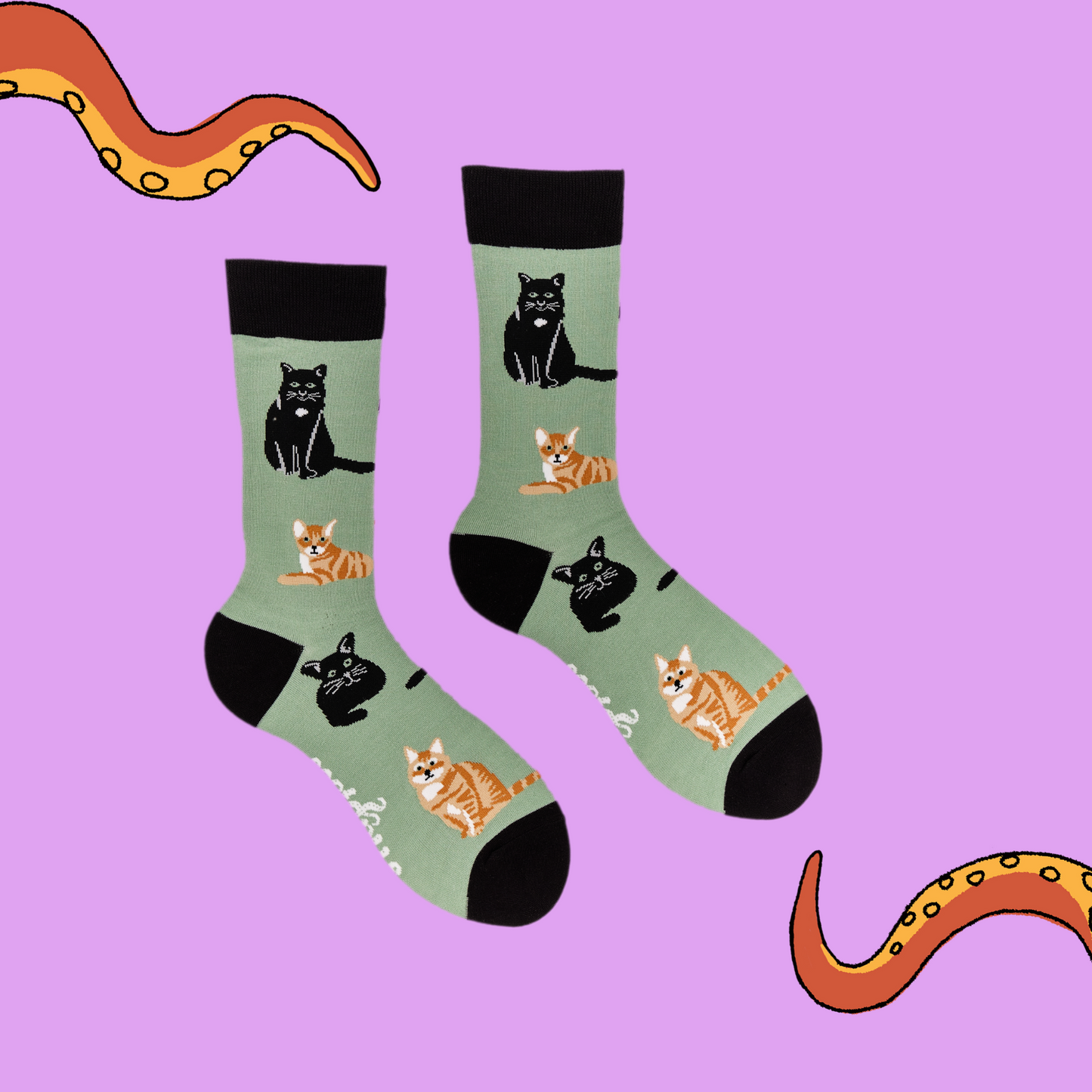 
                  
                    A pair of socks depicting cats. Green legs, black cuff, heel and toe.
                  
                