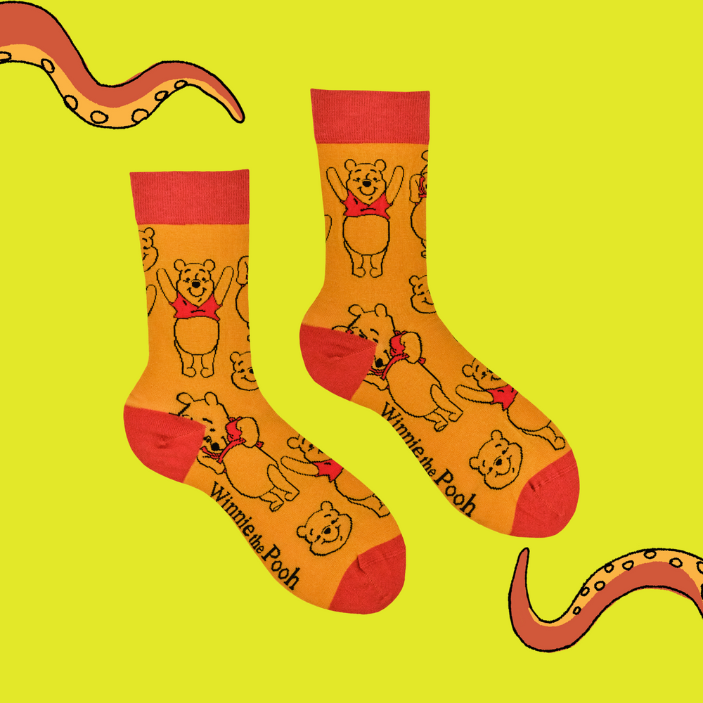 
                      
                        A pair of socks featuring Winne the Pooh. Yellow legs, red toe, cuff and heel. 
                      
                    