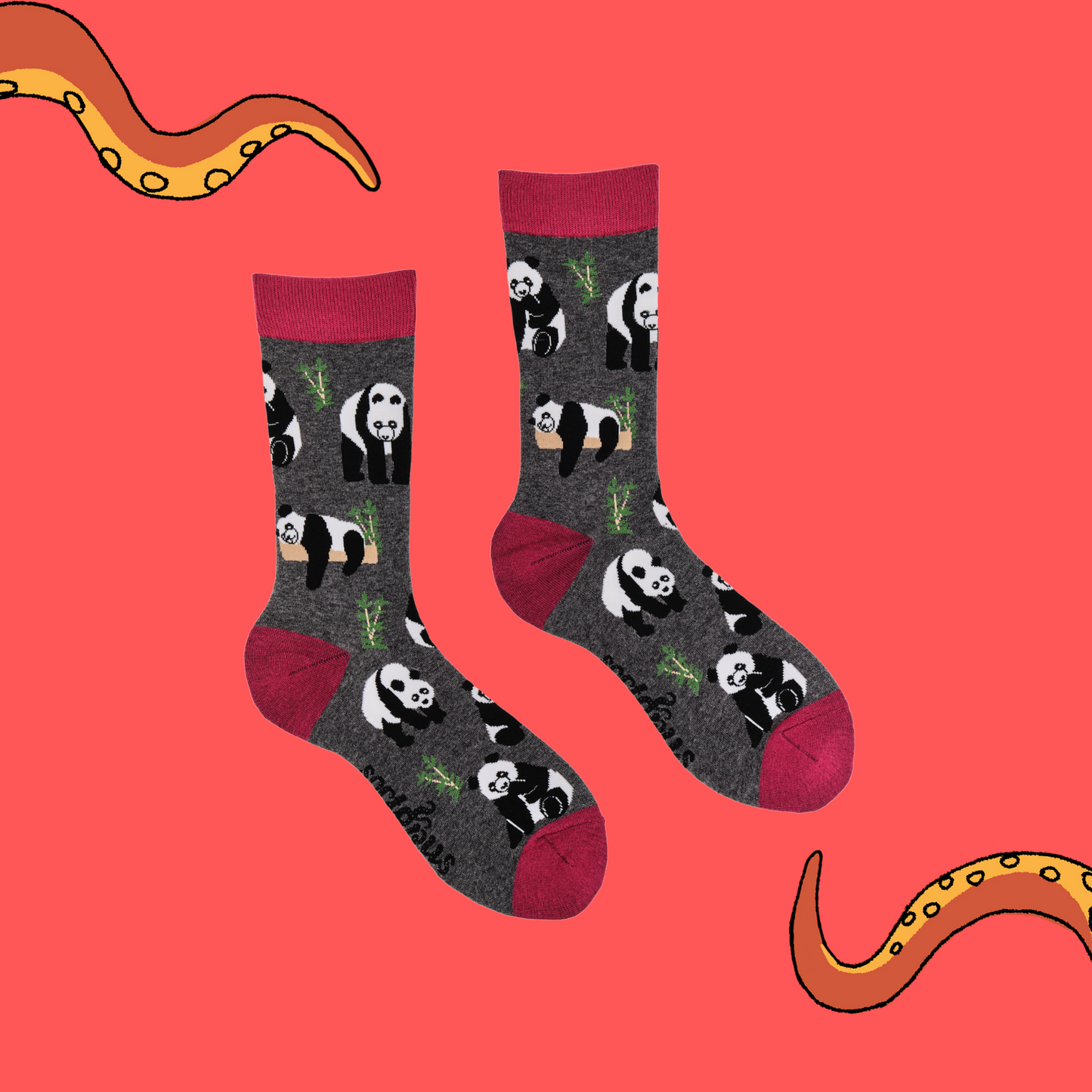 
                  
                    A pair of socks depicting pandas playing in the forest. Grey legs, red cuff, heel and toe.
                  
                