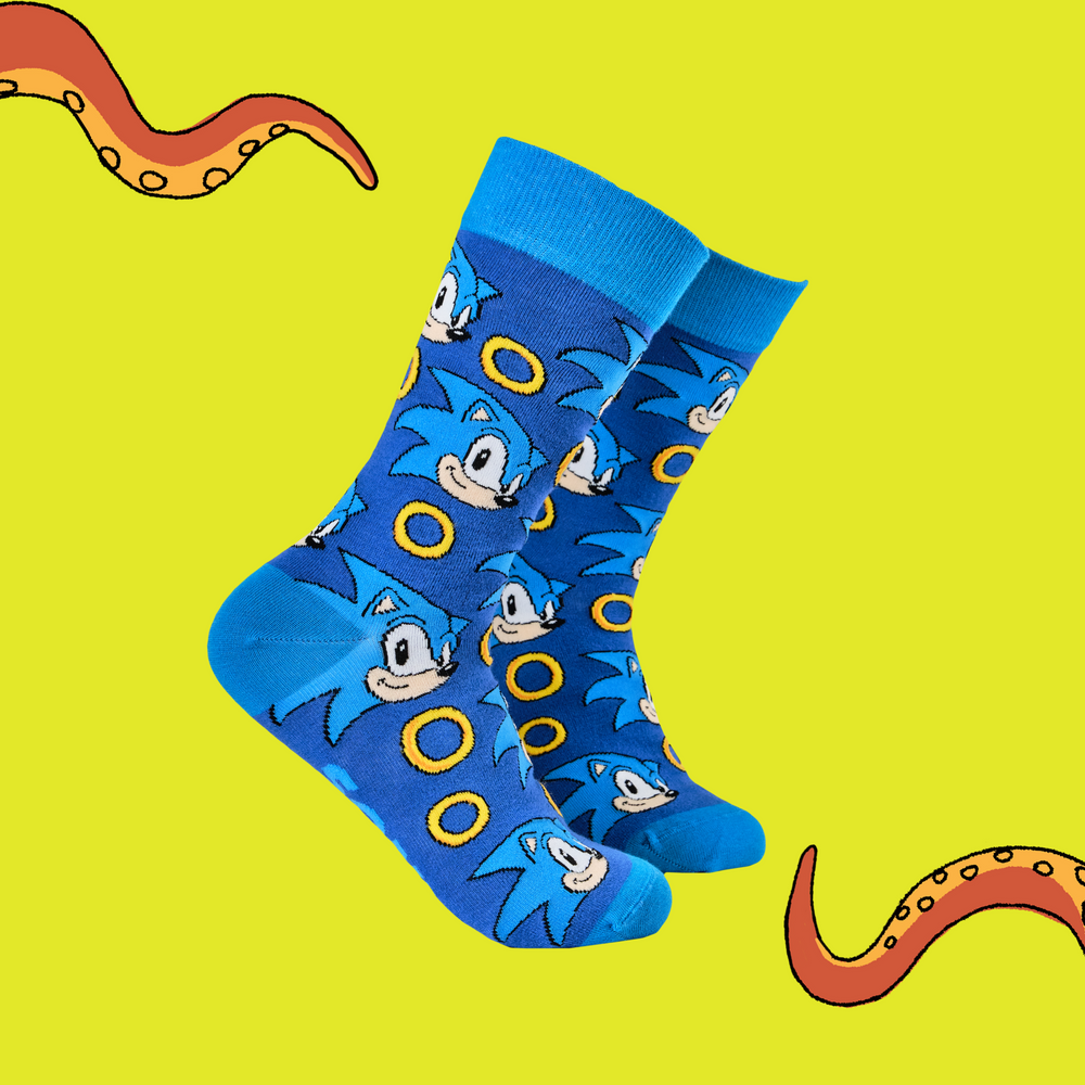 
                      
                        A pair of socks featuring Sonic with power rings. Dark blue legs, light blue heel, cuff and toe. 
                      
                    