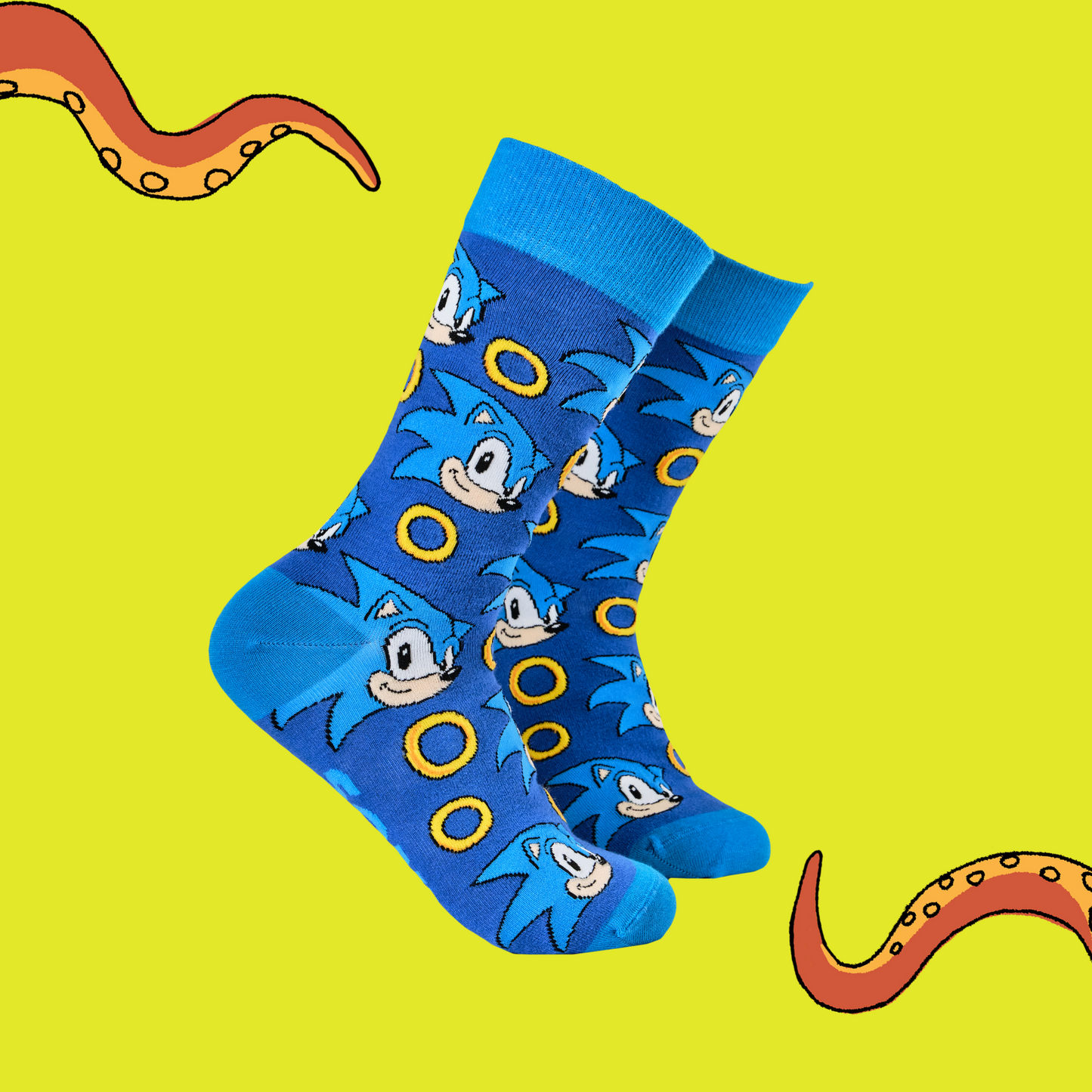 A pair of socks featuring Sonic with power rings. Dark blue legs, light blue heel, cuff and toe. 