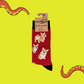 A pair of socks depicting corgis. Red legs, black cuff, heel and toe. In Soctopus Packaging.